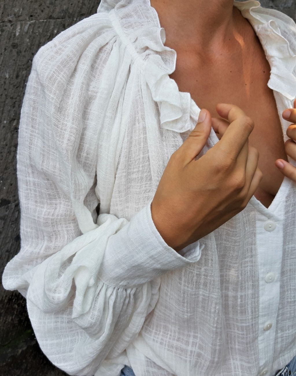 White top in textured cotton for an airy look and feel-deep v-neck with button front-ruffle collar-billowed sleeves with statement cuff-Nifty